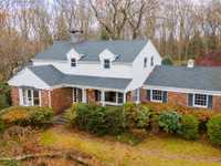 METICULOUSLY MAINTAINED RETREAT ON TWO WOODED ACRES