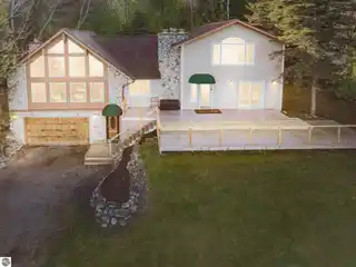 Fully Furnished Lake Charlevoix Home with Dock, Pole Barn & Stunning Views