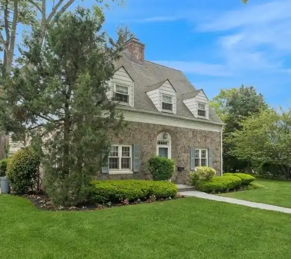 SURPRISINGLY SPACIOUS STONE AND BRICK CENTER-HALL COLONIAL