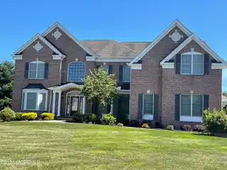Brick Front Beauty with Dramatic Curved Staircase