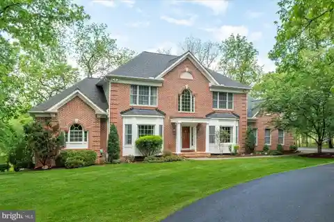 Elegant Brick Colonial with Wooded Serenity