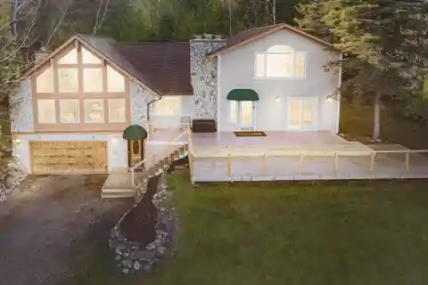 Fully Furnished Lake Charlevoix Home with Dock, Pole Barn & Stunning Views