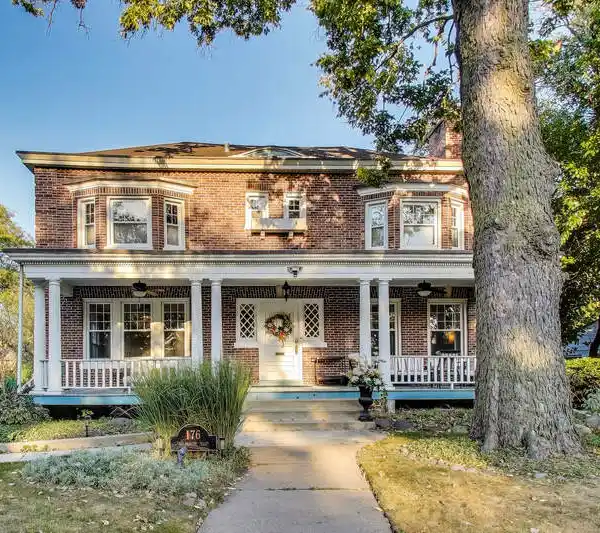 TIMELESS RIVERSIDE ELEGANCE WITH ICONIC FRONT PORCH & MODERN UPGRADES