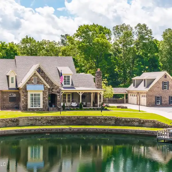 CUSTOM HOME ON EIGHT WOODED ACRES WITH POND