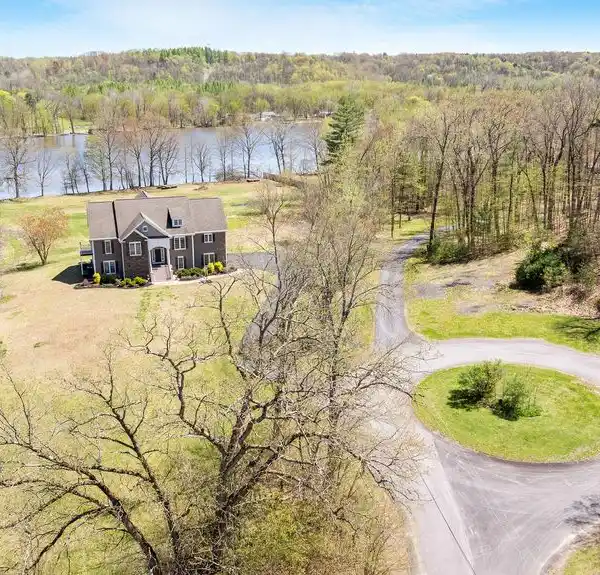 COMFORTABLE RIVERFRONT LIVING ON OVER THREE ACRES