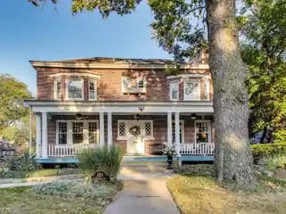 Timeless Riverside Elegance with Iconic Front Porch & Modern Upgrades