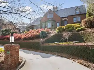 Brick Tudor Home with Carriage House