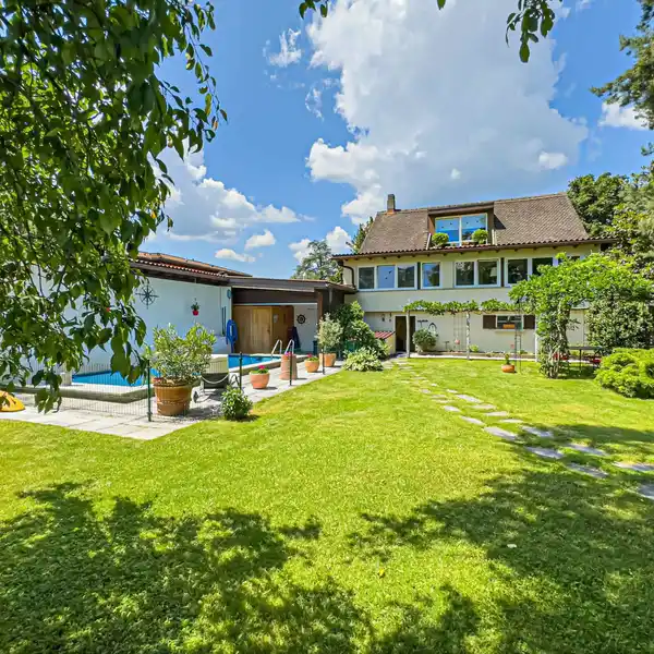 VILLA NESTLED IN LUSH GREENERY FEATURING A SWIMMING POOL AND PROXIMITY TO LAKE LUGANO