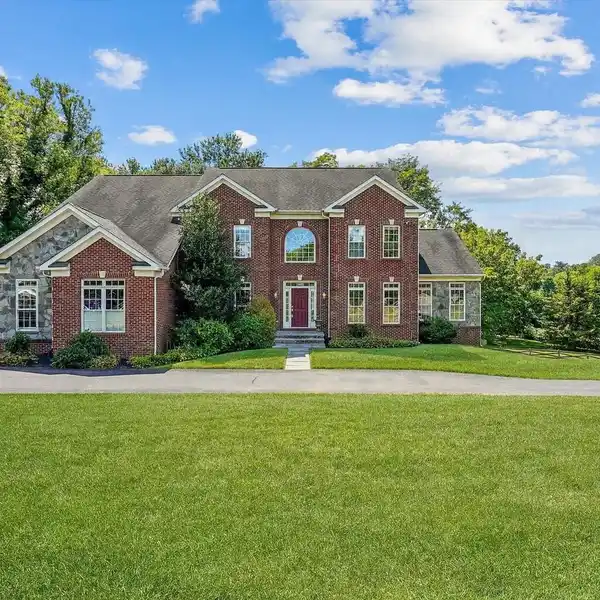 EXPANSIVE BRICK AND STONE FRONT COLONIAL
