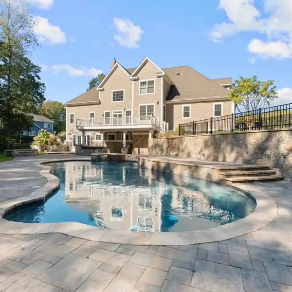 GORGEOUS WOODLAND SETTING WITH CUSTOM STONE WALLS AND LANDSCAPING