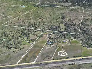 Huge Acreage with Farmhouse and Multiple Outbuildings