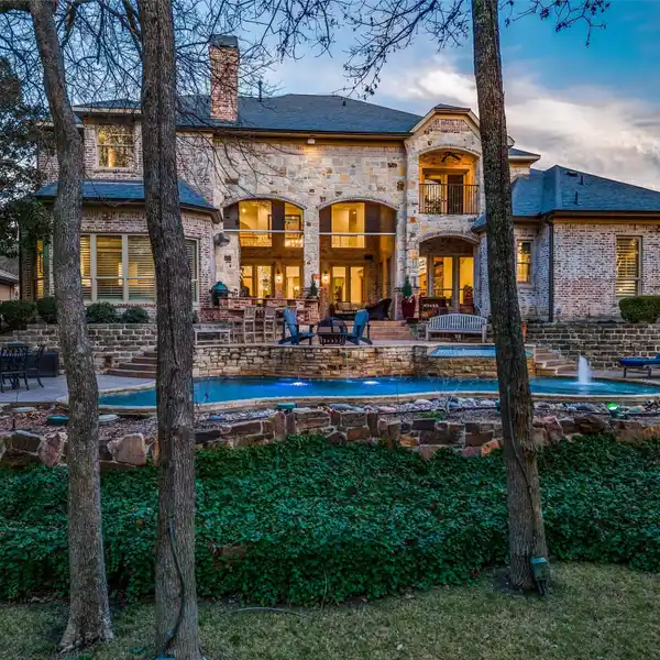 CUSTOM HOME BY AWARD WINNING BUILDER ON 1/2 ACRE CREEK LOT IN GATED NEIGHBORHOOD