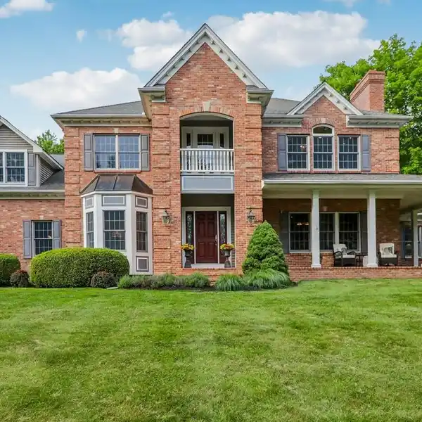 DISTINGUISHED BRICK COLONIAL ON A GENTLE HILL