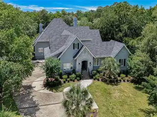 Step into the Charm of Lowcountry Living with This Beautifully Renovated Retreat on a Serene Saltwater Lagoon in the Prestigious Colleton River Club.