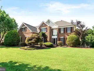 Spectacular Brick Front Colonial Situated on a Picturesque Lot
