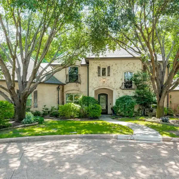 STUNNING HOME ON AN ENCHANTING .43 ACRE CREEK LOT