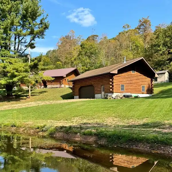 PICTURESQUE LOG HOME ON 90 ACRES
