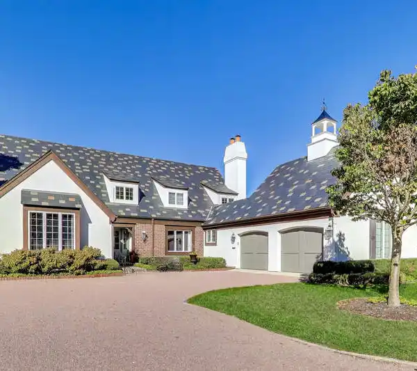 GRAND TWO-STORY FAMILY ROOM WITH LIMESTONE FIREPLACE