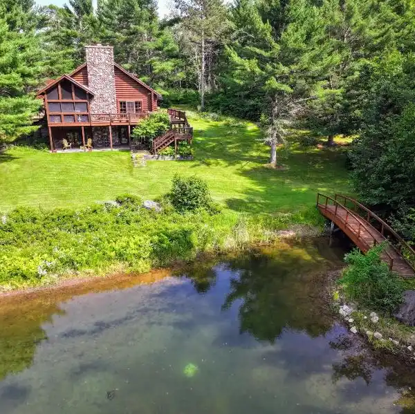 NORTHWOODS LUXURY LOG HOME WITH ACREAGE