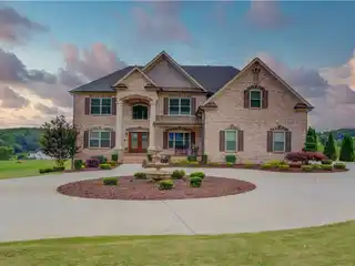 Grand Two-Story Foyer with Rich Hardwood Floors