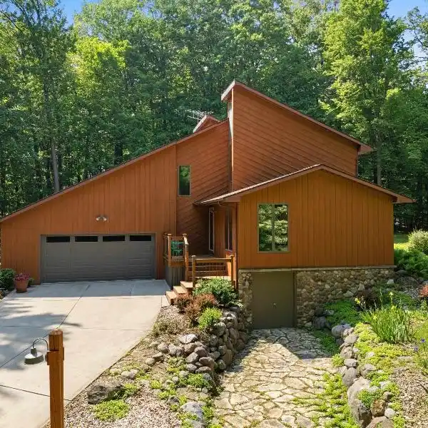 METICULOUSLY CARED FOR HOME ON A WOODED RETREAT
