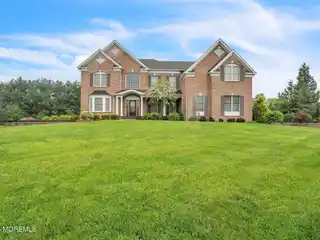 Brick Front Beauty with Dramatic Curved Staircase
