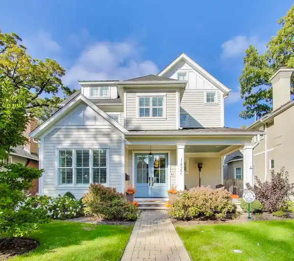 WELCOMING FRONT PORCH WITH STUNNING BLUE DOUBLE DOORS