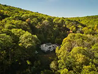 Serene Estate Surrounded by Forest and Rock Outcroppings