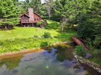 NORTHWOODS LUXURY LOG HOME WITH ACREAGE
