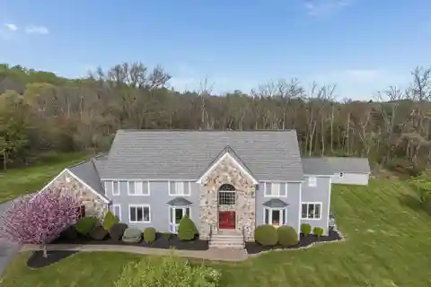 Stunning Stone Colonial with Expansive Woods View