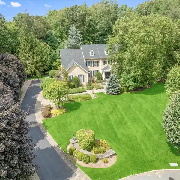 TIMELESS CENTER-HALL COLONIAL SET ON BEAUTIFULLY LANDSCAPED GROUNDS