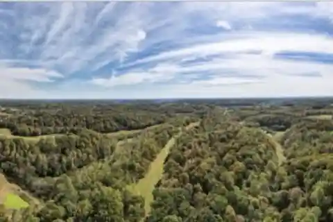 Expansive Hilltop Farmstead with Scenic Pastures