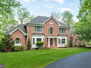 Elegant Brick Colonial with Wooded Serenity