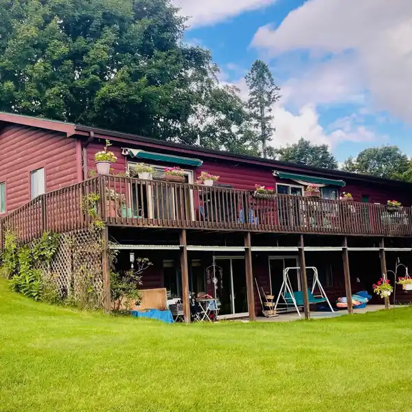 LOG SIDED DUAL LEVEL LAKE HOME