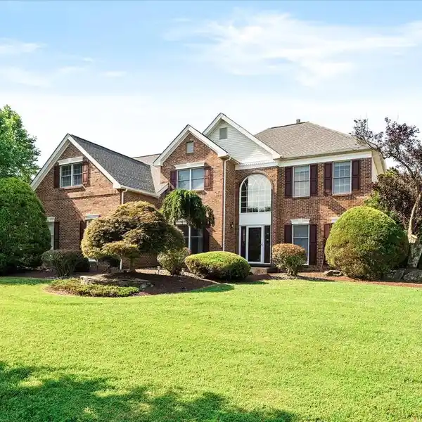 SPECTACULAR BRICK FRONT COLONIAL SITUATED ON A PICTURESQUE LOT