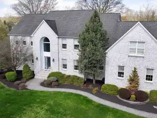 Elegant Home Boasts Grand Staircase and Pool