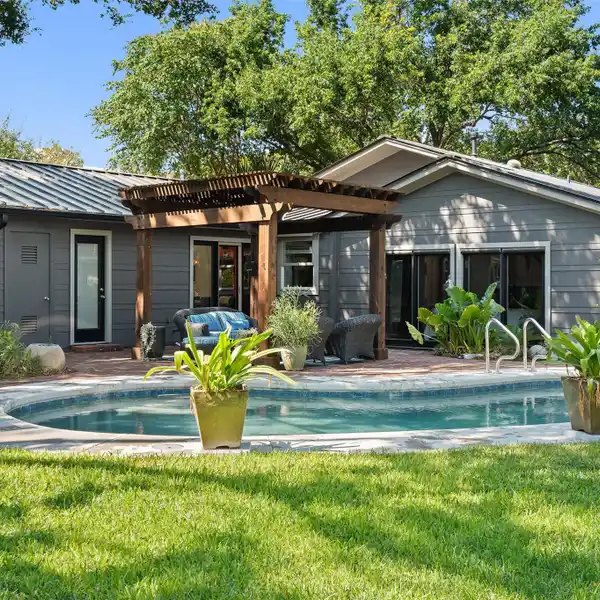 UPDATED MID-CENTURY MODERN HOME ON A PRIVATE LOT IN BARTON HILLS