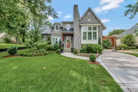 Storybook Modern Tudor Home with Carriage House