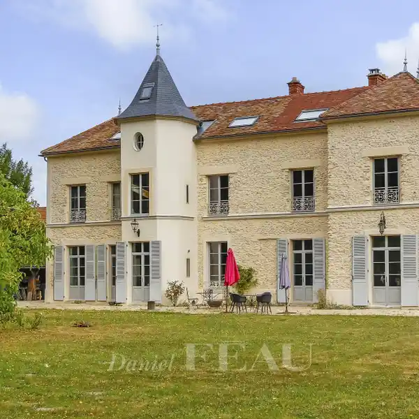 RENOVATED MANOR HOME IN A WOODED SETTING