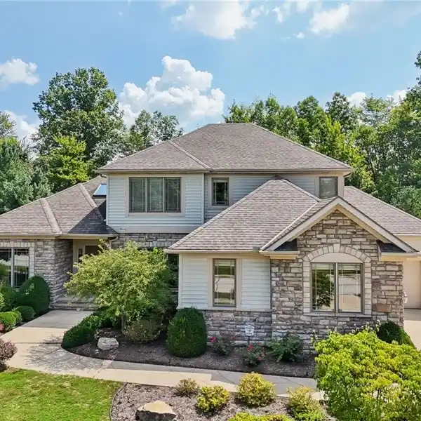 LOW-MAINTENANCE LUXURY WITH EXPANSIVE WOODED VIEWS