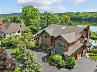 Contemporary Colonial Overlooking Serene Lake Deforest