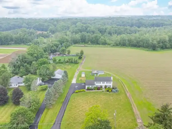 COLONIAL CHARM ON 20+ FARM-READY ACRES