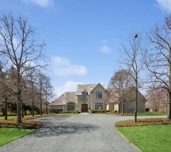 CLASSIC FRENCH MANOR HOME EXUDES TIMELESS ELEGANCE AND SOPHISTICATION.
