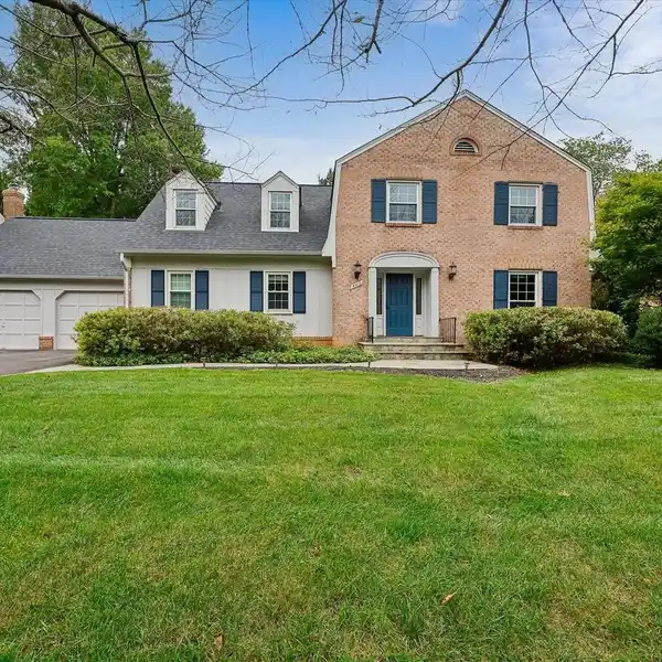EXPANDED COLONIAL WITH SCREENED PORCH AND GARDEN VIEWS