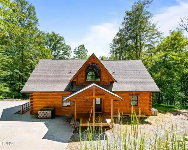 CUSTOM LOG HOME SET ON NEARLY TWO ACRES