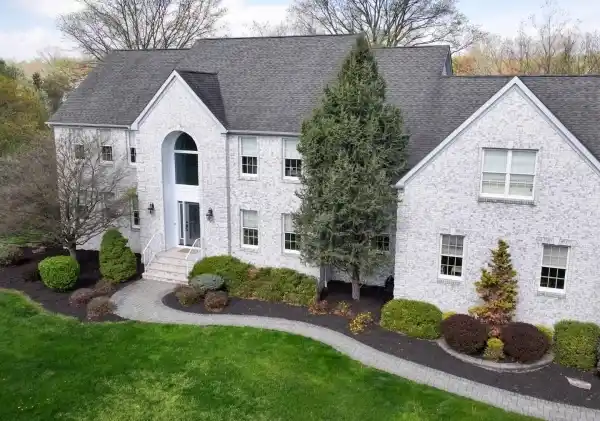 ELEGANT HOME BOASTS GRAND STAIRCASE AND POOL