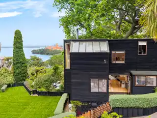 Architectural Coastal Haven Framed by Majestic Oak