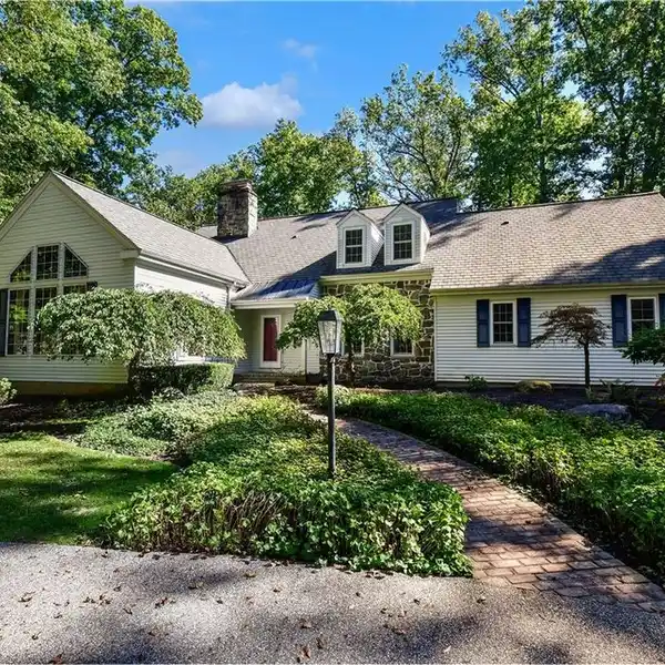 SPRAWLING CAPE ON A MAGNIFICENT WOODED LOT