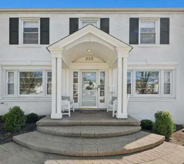 STUNNINGLY UPDATED WHITE PAINTED BRICK COLONIAL