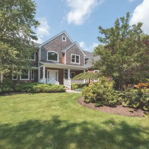 REFINED QUOGUE RETREAT WITH TENNIS AND POOLSIDE LUXURY